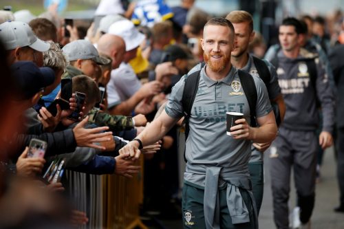 Leeds United's Adam Forshaw interacts with fans after arriving at Elland Road before the Swansea match, Aug 2019