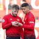 Manchester United's Luke Shaw and Marcos Rojo read a note from Manchester United manager Ole Gunnar Solskjaer during the Watford match, March 2019