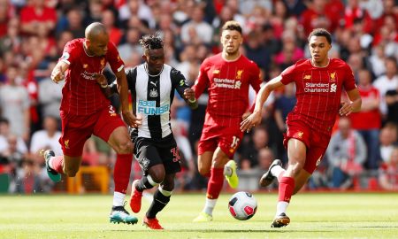 Newcastle United's Christian Atsu in action with Liverpool's Fabinho and Trent Alexander-Arnold