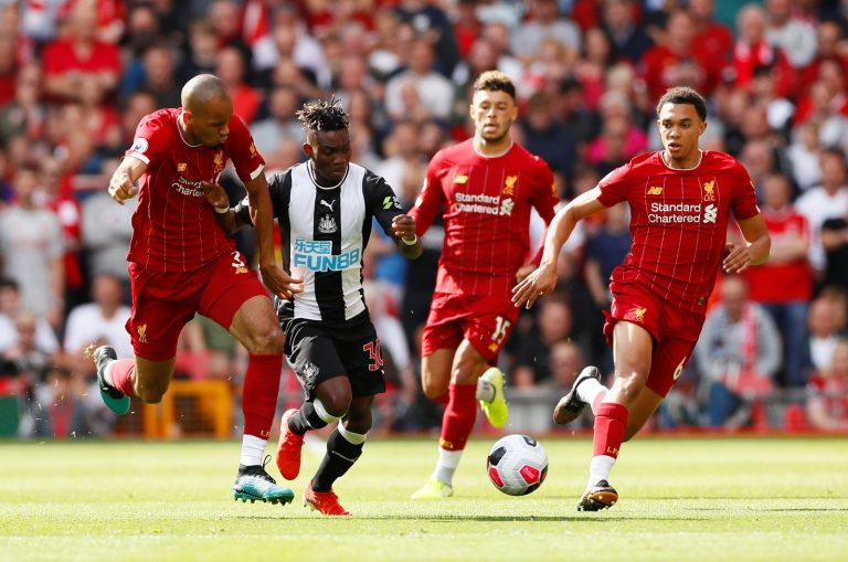 Newcastle United's Christian Atsu in action with Liverpool's Fabinho and Trent Alexander-Arnold