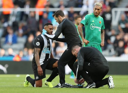 Newcastle United's Jamaal Lascelles receives medical attention after sustaining an injury v Watford