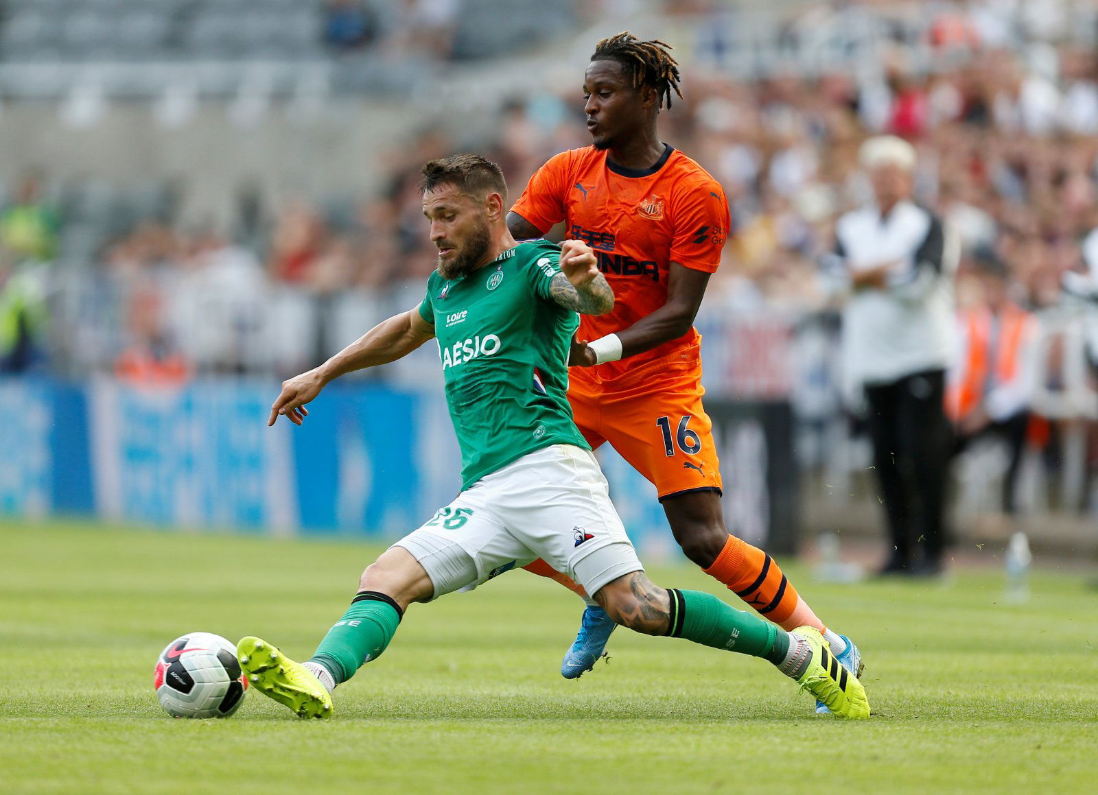 Newcastle United's Rolando Aarons in action with St Etienne's Mathieu Debuchy