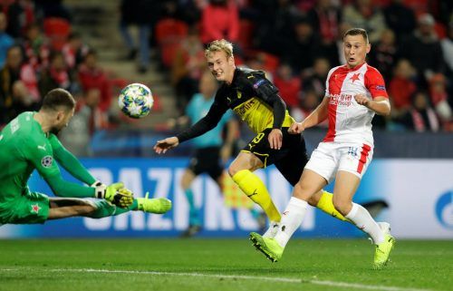 Borussia Dortmund's Julian Brandt shoots at goal as Slavia Prague's Ondrej Kolar attempts to save and Jan Boril reacts