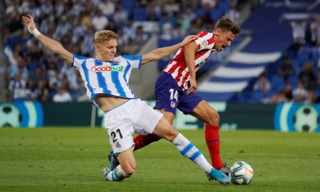 Real Sociedad's Martin Odegaard in action with Atletico Madrid's Marcos Llorente