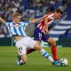 Real Sociedad's Martin Odegaard in action with Atletico Madrid's Marcos Llorente