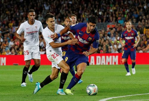 chelsea target sergio reguilon tussles with luis suarez.