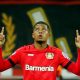 bayer leverkusens leon bailey celebrates scoring against borussia dortmund.