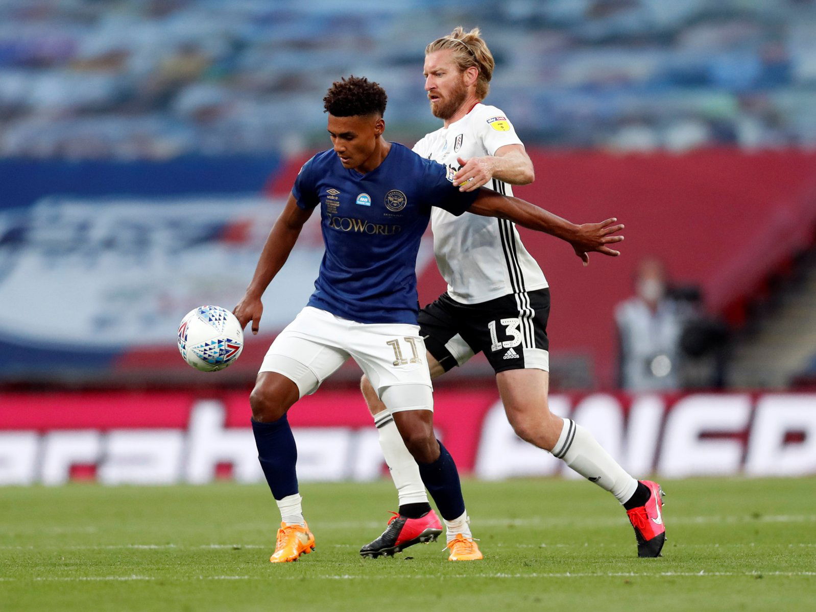 brentfords ollie watkins tussles with fulhams tim ream.