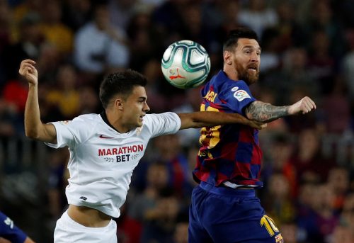 spurs and leicester target serigo reguilon tussles with lionel messi.