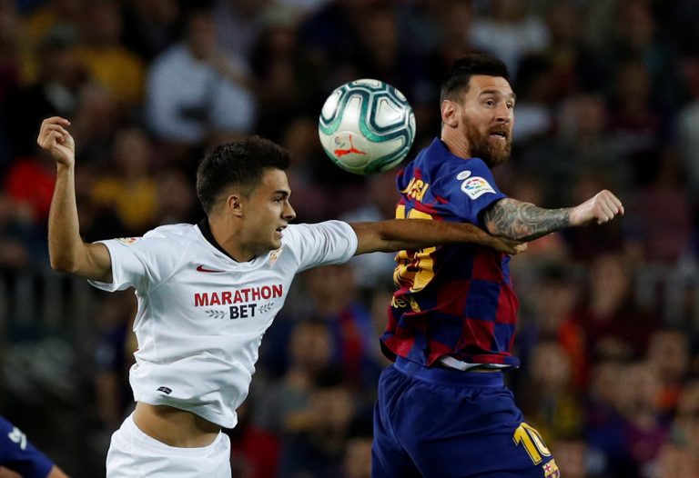 spurs and leicester target serigo reguilon tussles with lionel messi.