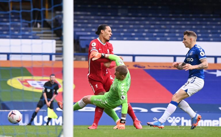Liverpool's-Virgil-van-Dijk-collides-with-Everton's-Jordan-Pickford