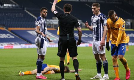 darnell-furlong-receives-a-yellow-card-vs-everton