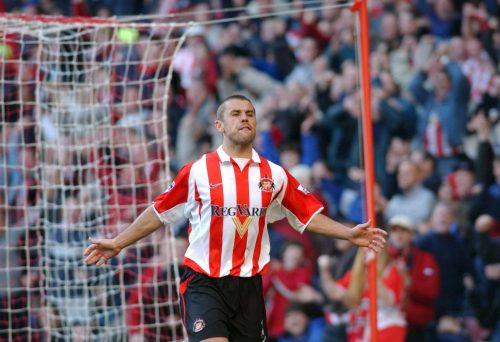 Phillips with his arms up celebrating