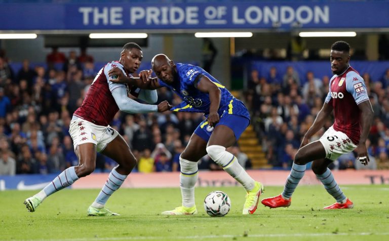 Kortney Hause and Axel Tuanzebe of Aston Villa challenge Lukaku