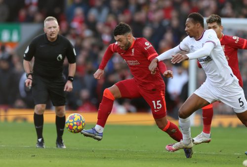 Alex Oxlade-Chamberlain of Liverpool holds off an opponent