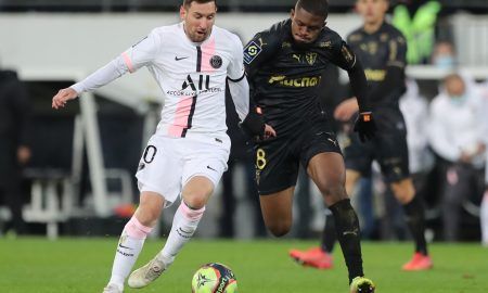 Cheick Doucoure fights Lionel Messi for the ball