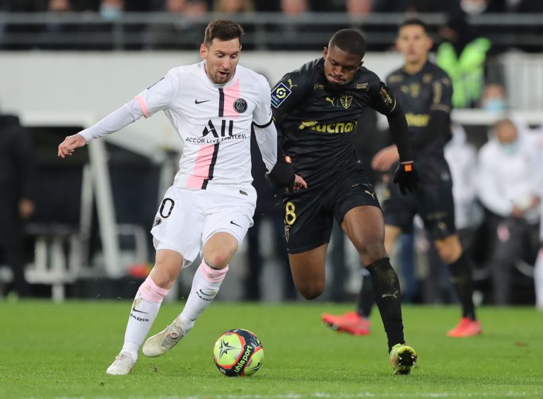 Cheick Doucoure fights Lionel Messi for the ball