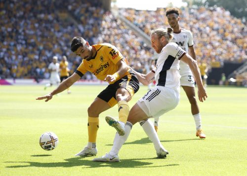 Wolves' Pedro Neto is challenged by Tim Ream