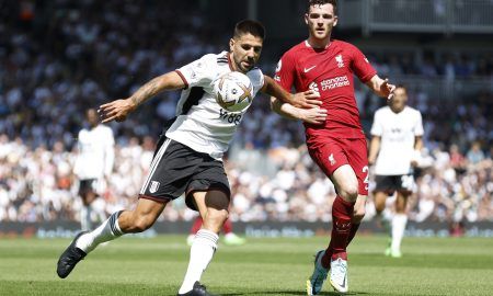 Liverpool's Andy Robertson in action with Aleksandar Mitrovic