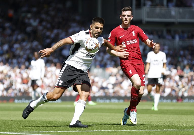 Liverpool's Andy Robertson in action with Aleksandar Mitrovic