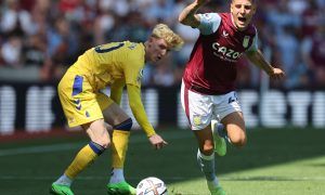 Aston Villa's Lucas Digne gets away from Anthony Gordon