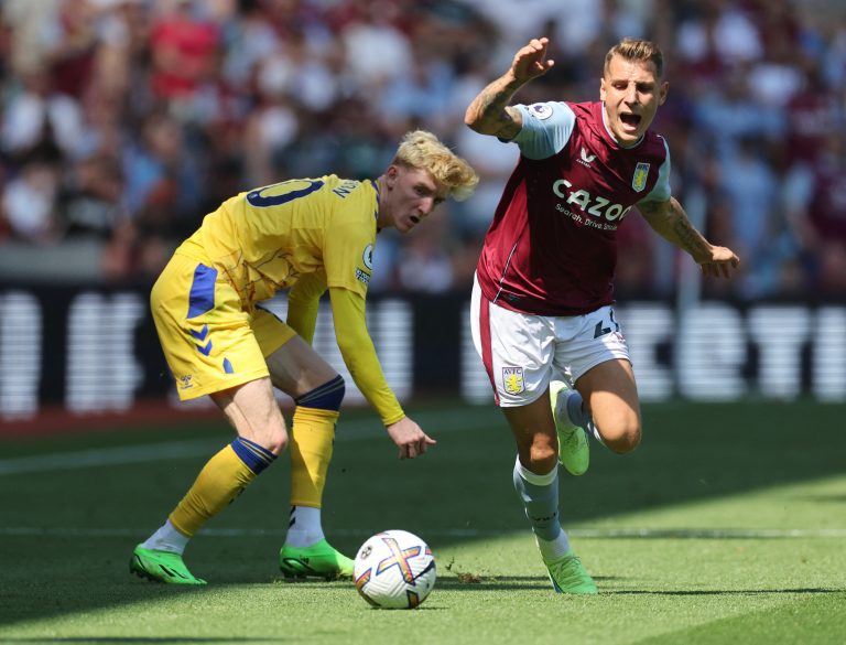Aston Villa's Lucas Digne gets away from Anthony Gordon