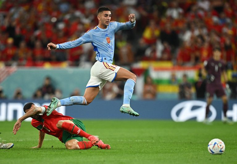 Spain's Ferran Torres in action with Morocco's Romain Saiss