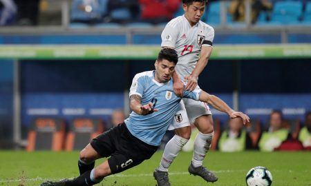 Uruguay's Luis Suarez in action with Japan's Tomoki Iwata