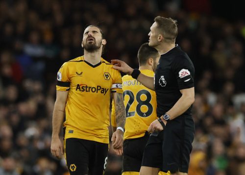 Wolverhampton Wanderers' Ruben Neves reacts after being shown a yellow card