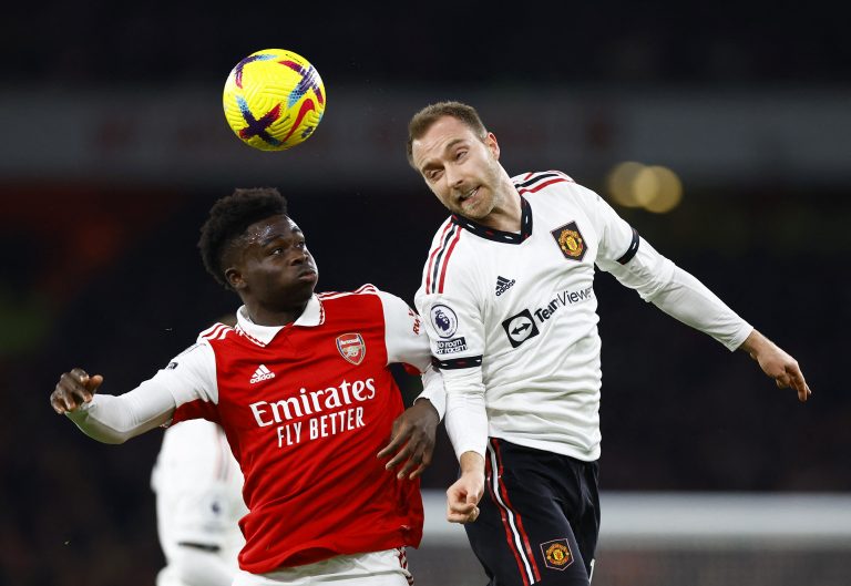 Manchester United's Christian Eriksen goes up for a header with Bukayo Saka