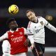 Manchester United's Christian Eriksen goes up for a header with Bukayo Saka
