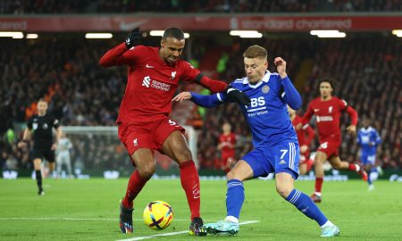 Liverpool's Joel Matip holds off Harvey Barnes