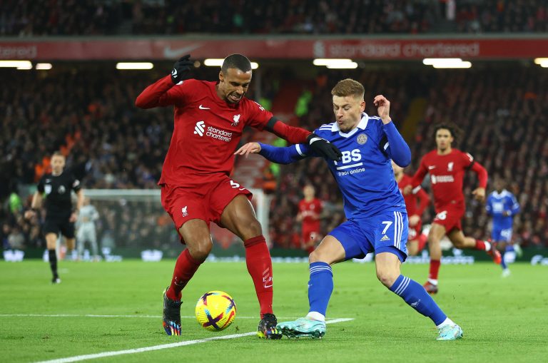 Liverpool's Joel Matip holds off Harvey Barnes