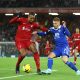 Liverpool's Joel Matip holds off Harvey Barnes