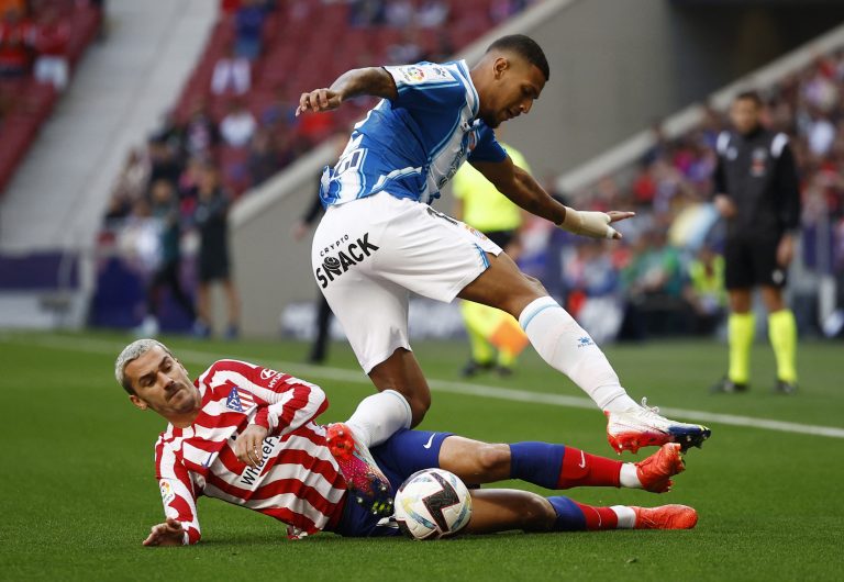 Atletico Madrid's Antoine Griezmann in action with Espanyol's Vinicius Souza