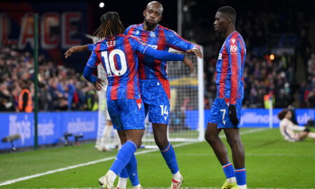 Soccer players embrace.