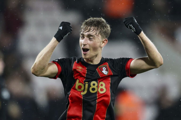 Soccer player with gloves in striped shirt.