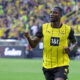 Soccer player in yellow jersey.