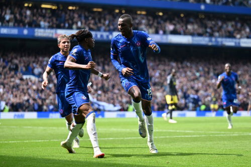 Chelsea players in Blue jerseys celebrate goal.