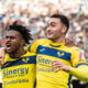Soccer players celebrate goal.