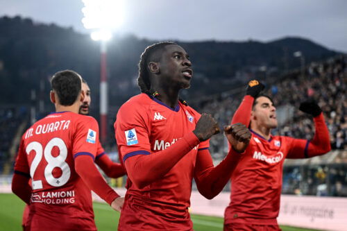 Striker in red shirt celebrates goal.