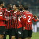 Soccer players huddle.