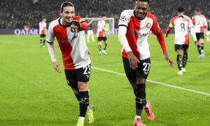 Soccer players celebrate goal.