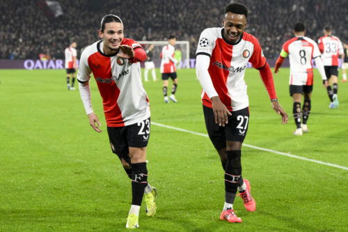 Soccer players celebrate goal.