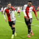 Soccer players celebrate goal.