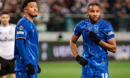 Two soccer players in blue jerseys.