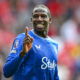 Soccer player in blue jersey smiles.