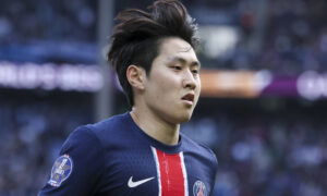 Soccer player in PSG jersey runs.