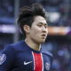 Soccer player in PSG jersey runs.