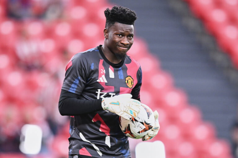 Soccer player with goalkeeper gloves on holds ball.